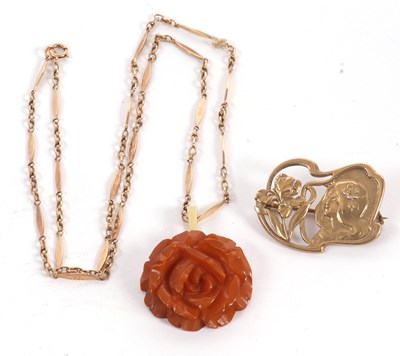 Lot 78 - A carved amber pendant and chain, the amber...