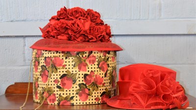 Lot 111 - A vintage red hat box decorated with red roses...