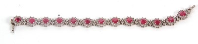 Lot 164 - A ruby and white topaz bracelet, comprised of...