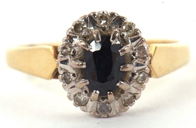 Lot 31 - An 18ct sapphire and diamond ring, the oval...