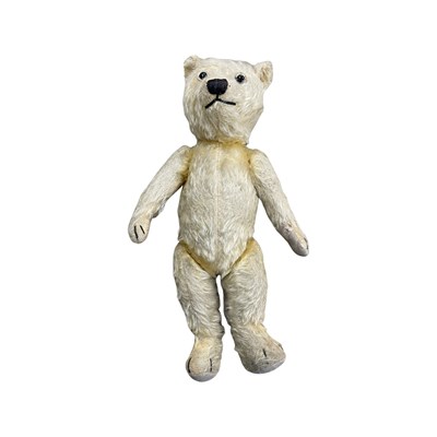 Lot 310 - A vintage straw-filled teddy bear with glass...