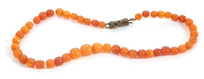 Lot 163 - An amber bead necklace, the slightly graduated...