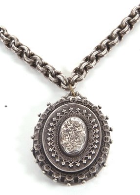 Lot 190 - A silver locket and chain, the oval silver...