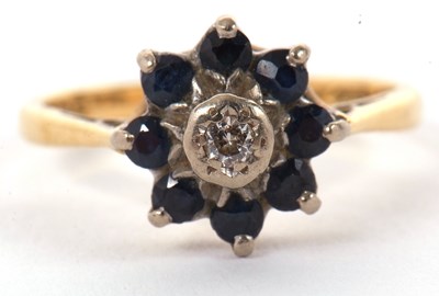 Lot 32 - An 18ct sapphire and diamond ring, the central...